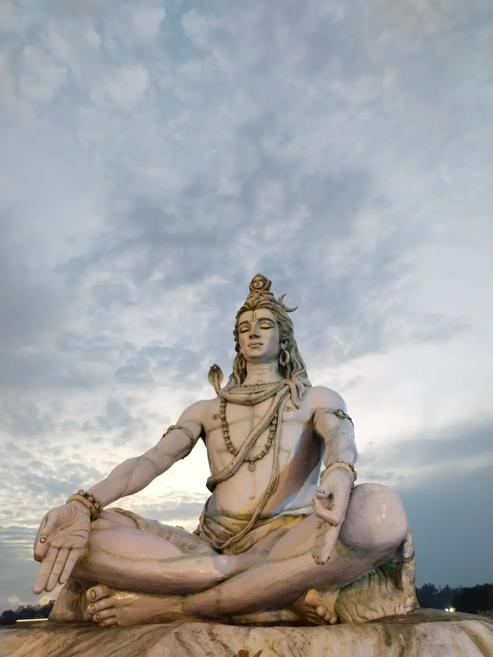 Majestic sculpture of Lord Shiva meditating in Rishikesh, India, captured during twilight.